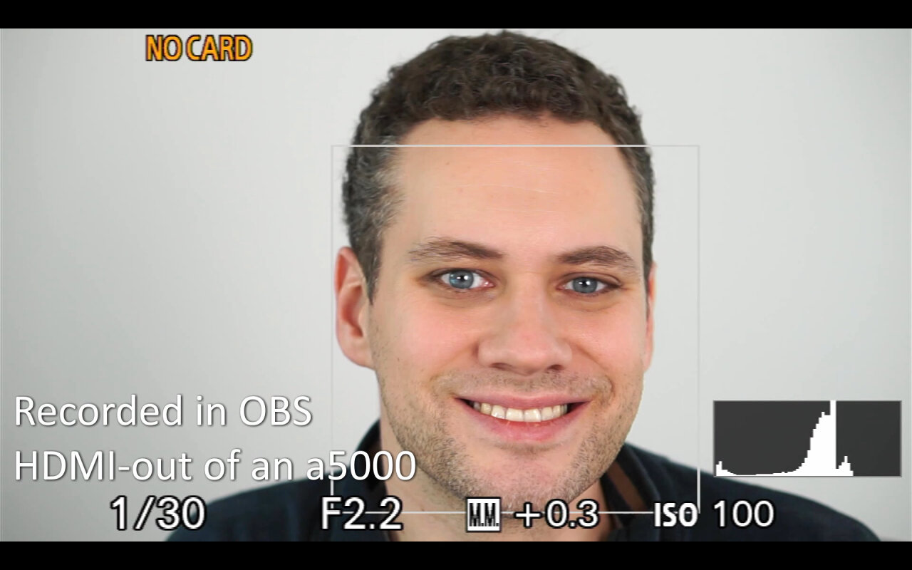 Recording from the a5000 showing an image of me looking into the camera. The image is clear, but there still is a user interface.